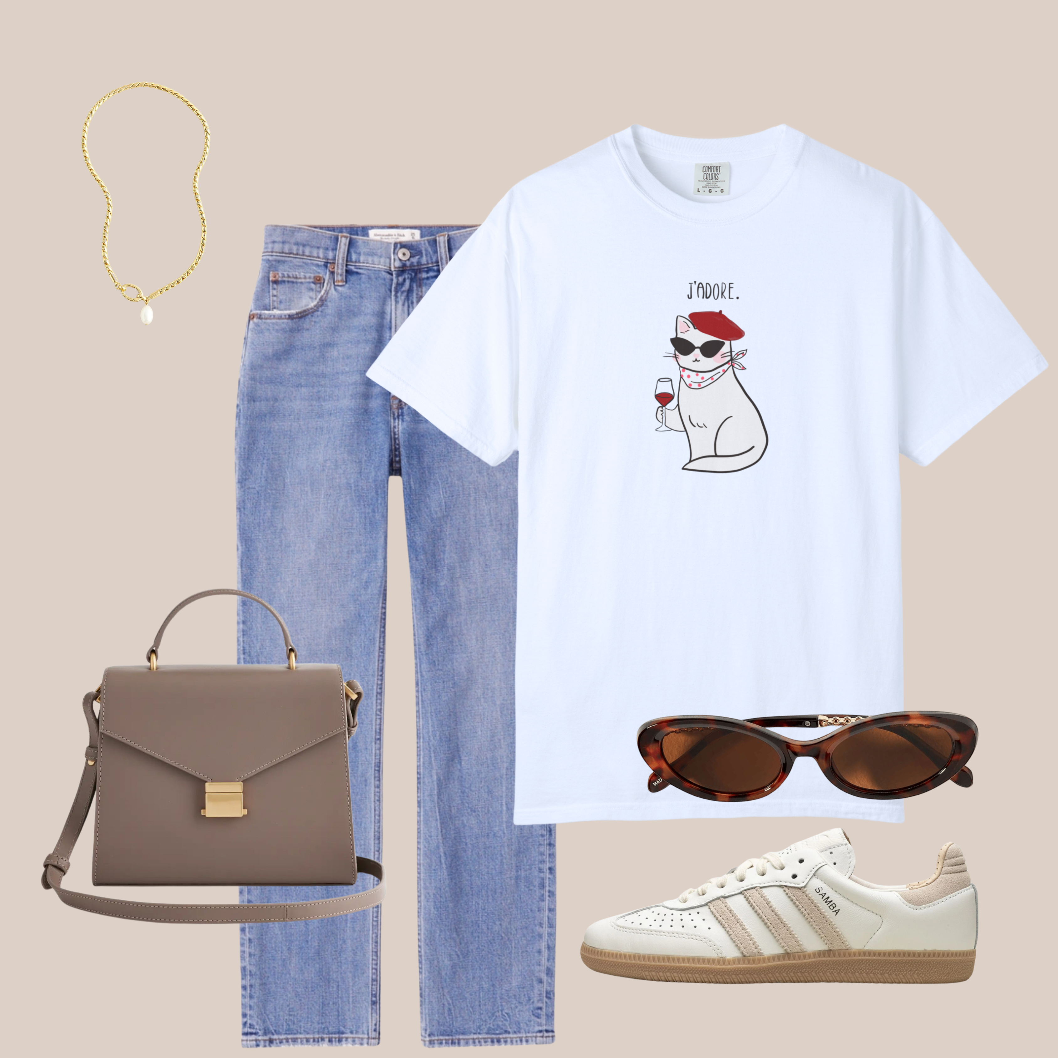 White Comfort Colors tee with illustrated cat wearing beret and holding wine glass, styled with light-wash jeans, sneakers, and brown sunglasses.