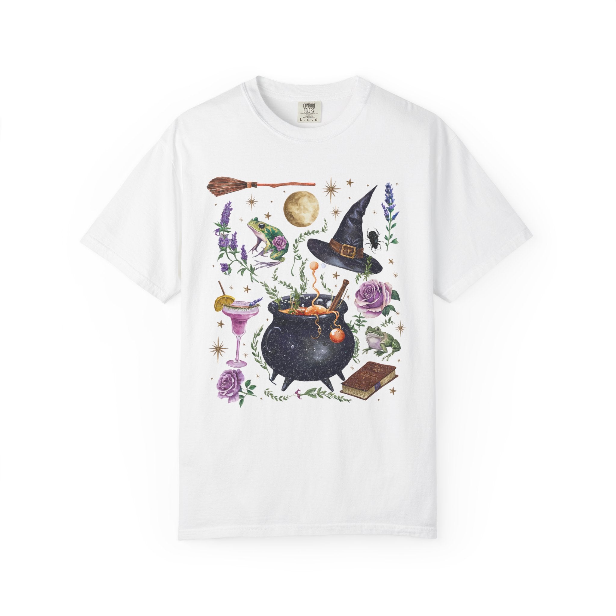 White t-shirt with Halloween-themed design featuring a witch hat, cauldron, and broomstick on a white background.