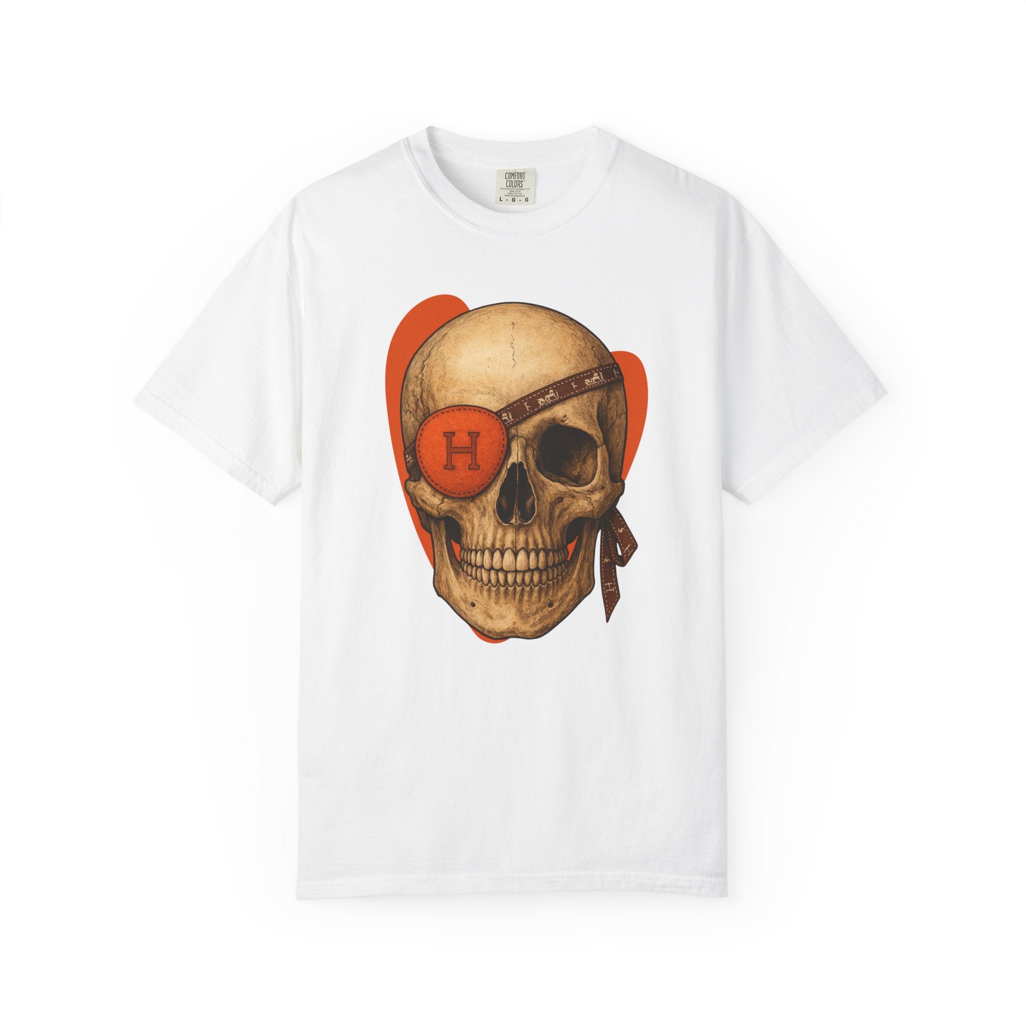 Ivory t-shirt featuring a graphic of a vintage skull with an orange designer eye patch and brown monogram headband, set against a red-orange heart background.