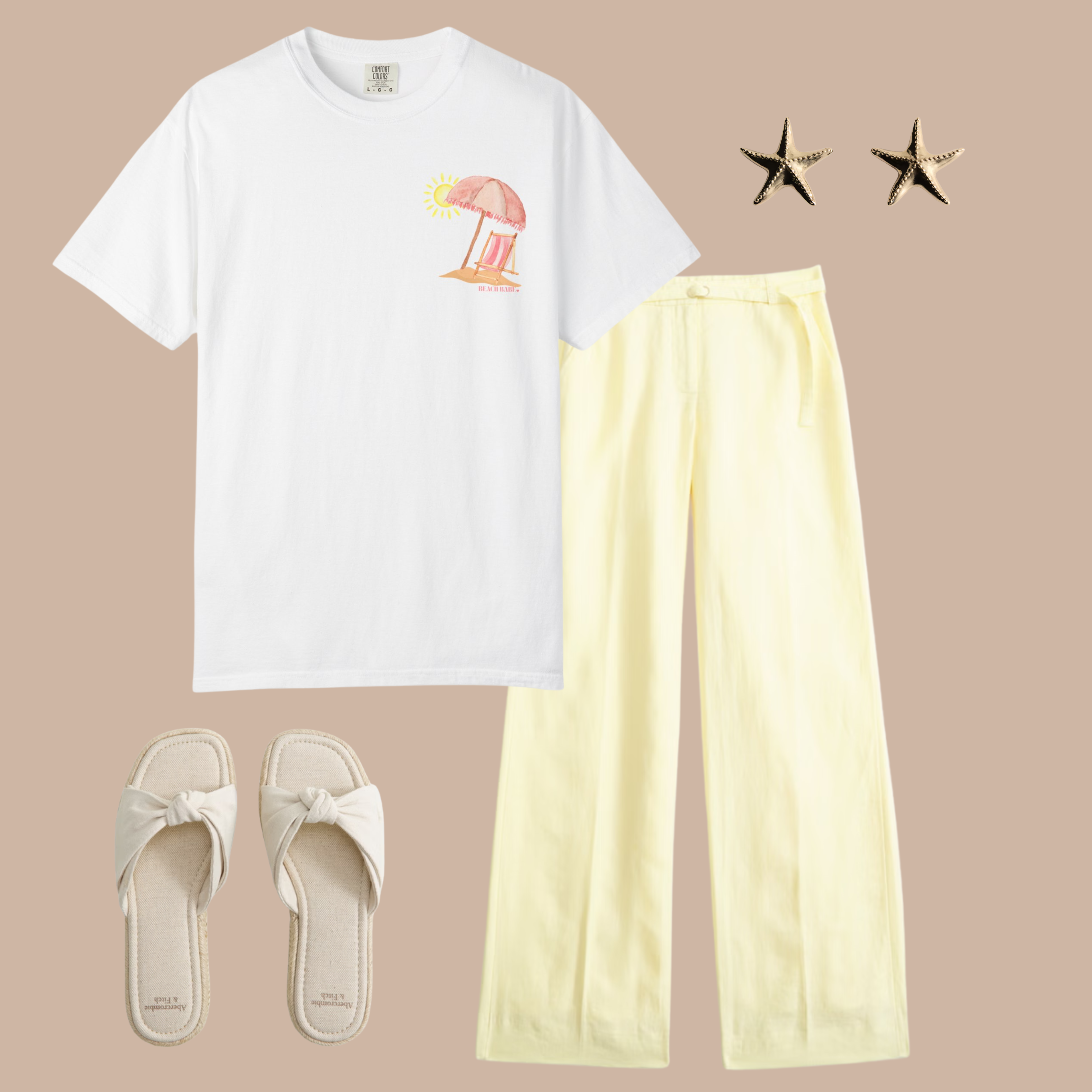 White Comfort Colors t-shirt with small pink beach umbrella and chair pocket-style graphic, styled with light yellow wide-leg pants and cream sandals.
