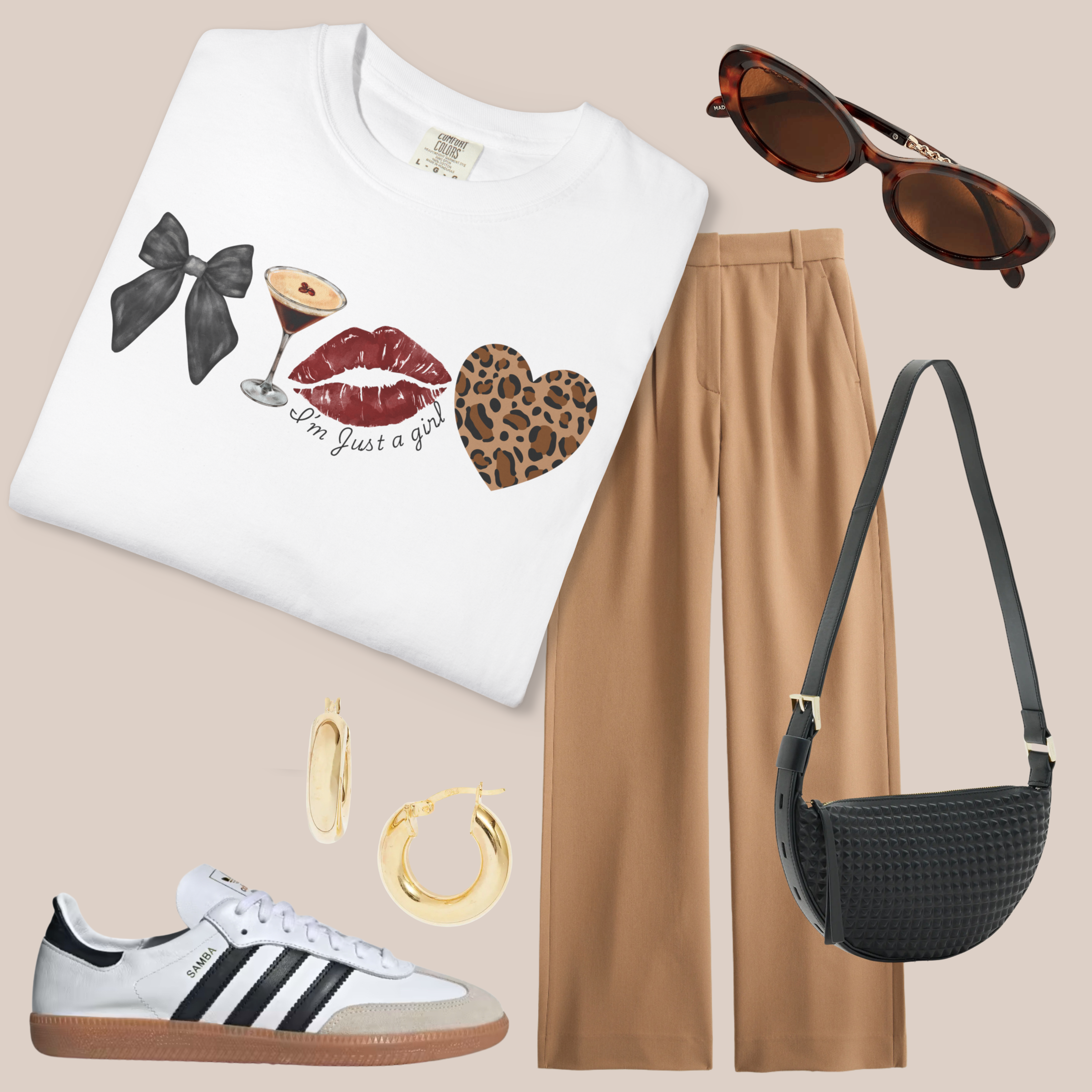 White Comfort Colors t-shirt with “I’m Just a Girl” bow, martini, lips, and leopard heart graphic, styled with tan trousers, black bag, and sneakers.