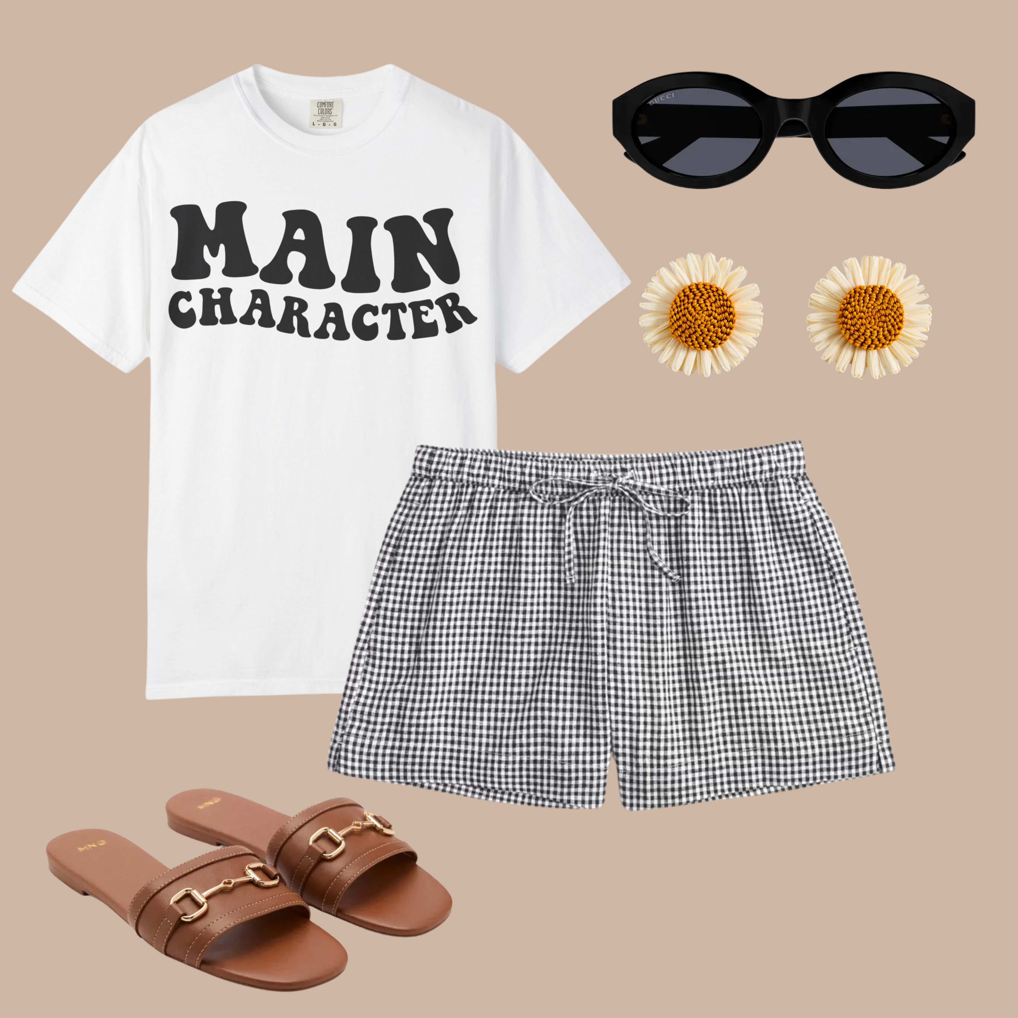 White Comfort Colors tee with bold black "MAIN CHARACTER" text, styled with black gingham shorts, brown sandals, round sunglasses, and daisy earrings.