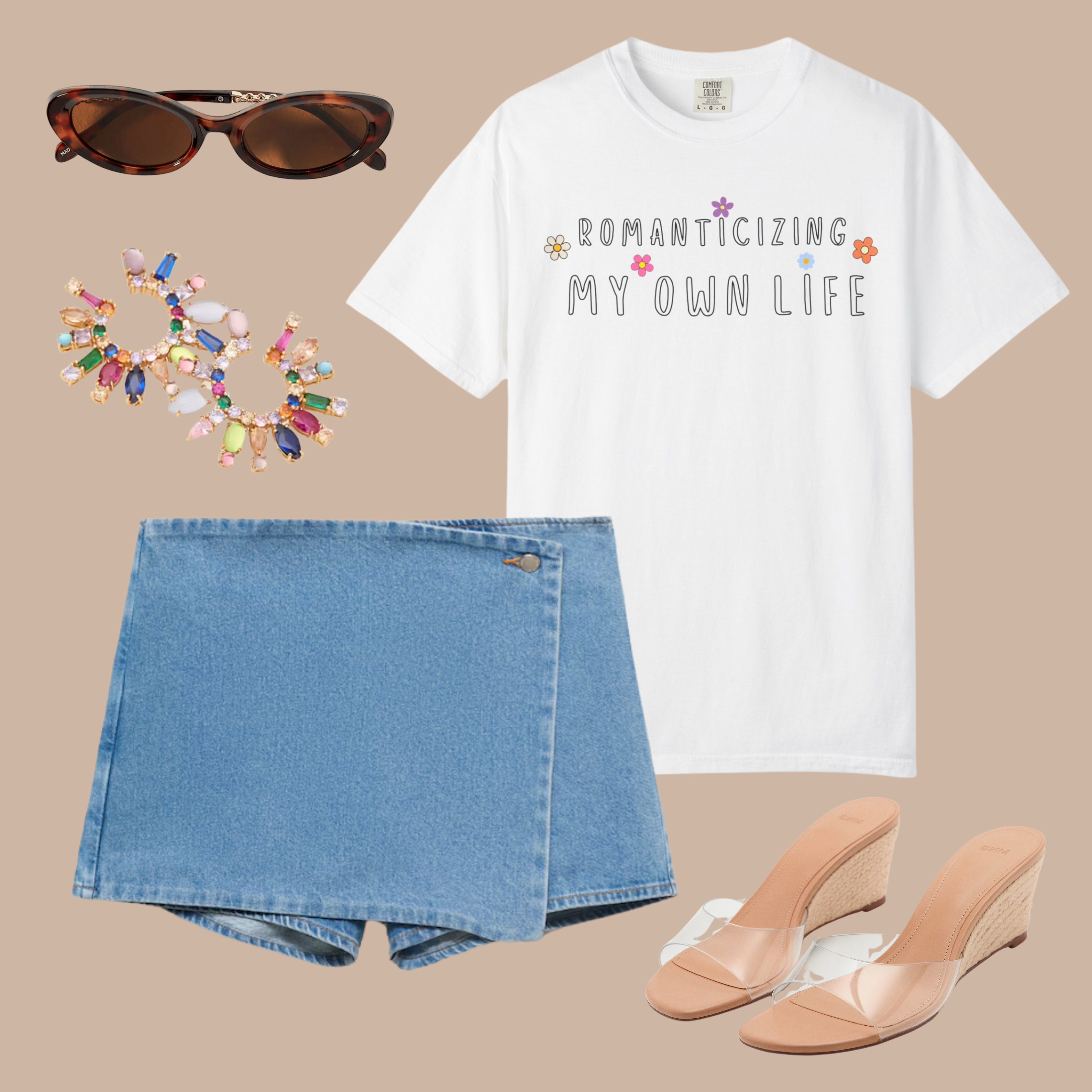 White Comfort Colors tee with “Romanticizing My Own Life” text and colorful floral accents, styled with a denim skort, wedges, and colorful earrings.

