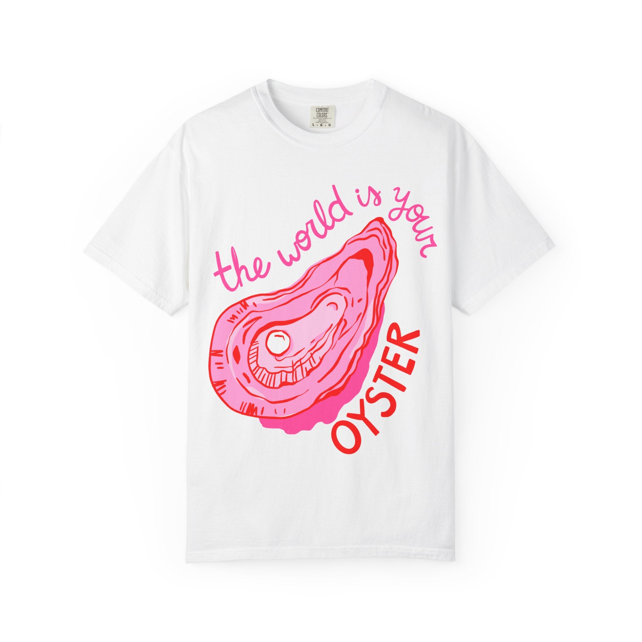 The World is Your Oyster graphic t-shirt with large pink oyster illustration and positive typography on white Comfort Colors tee.